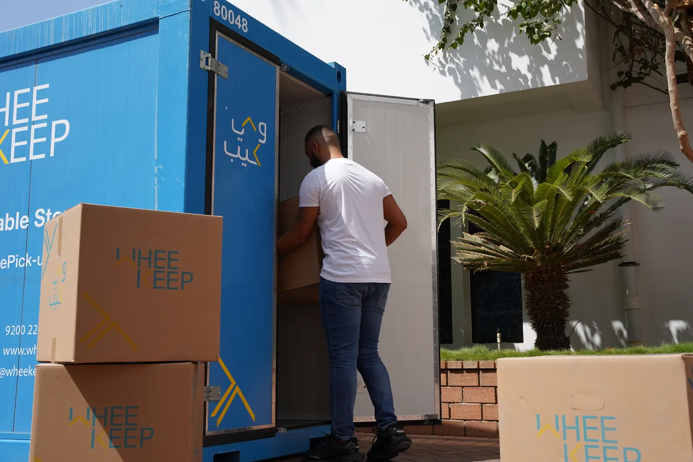Customer loading boxes into a WheeKeep portable storage unit